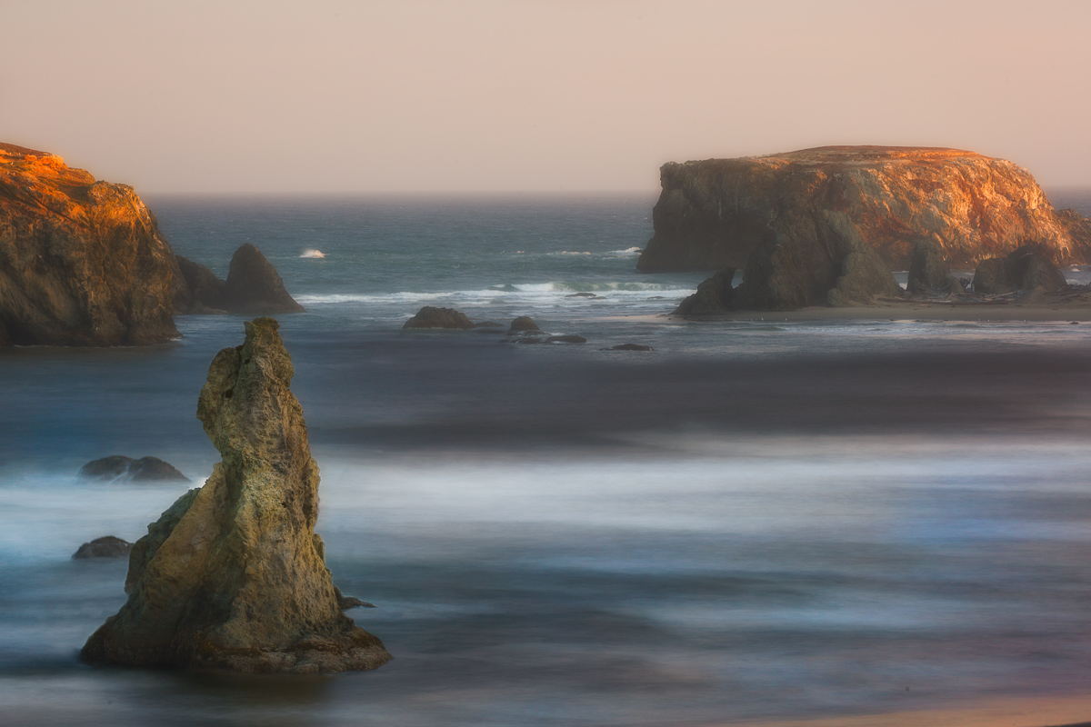 Bandon Beach at sunset with sea stacks and fast moving waves